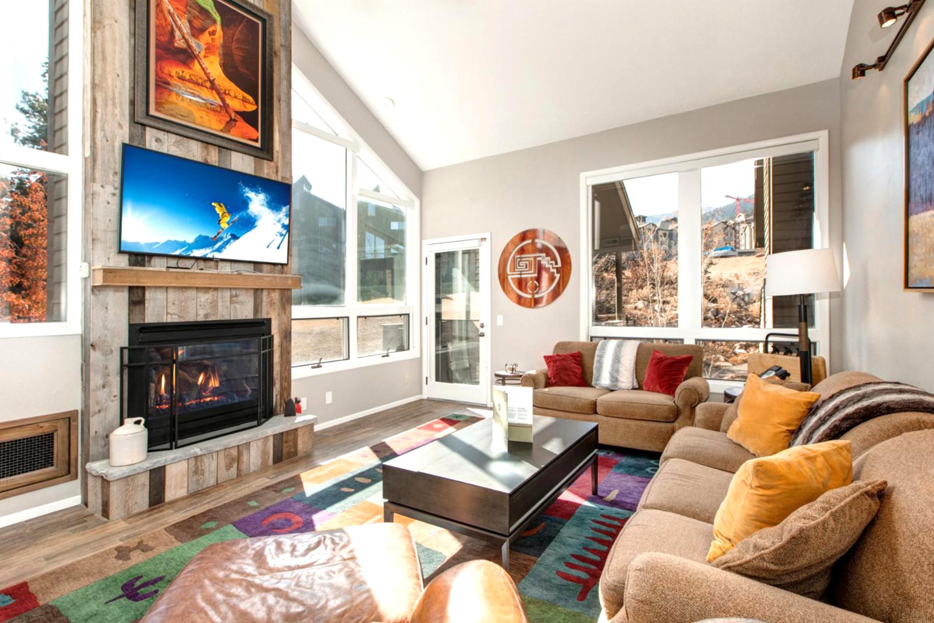 Gather in the cozy main living area with vaulted ceilings, a fireplace, and a Smart TV. Perfect for après-ski evenings.