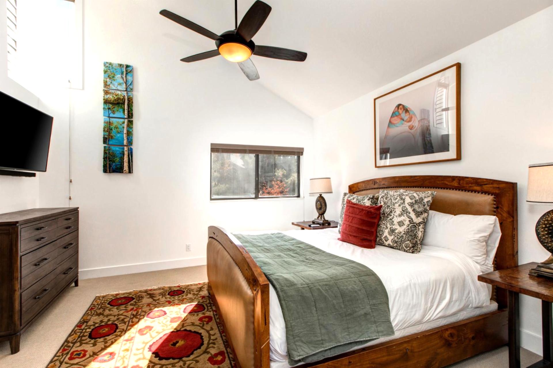 A closer look at the upstairs King suite, complete with Smart TV and plush bedding.