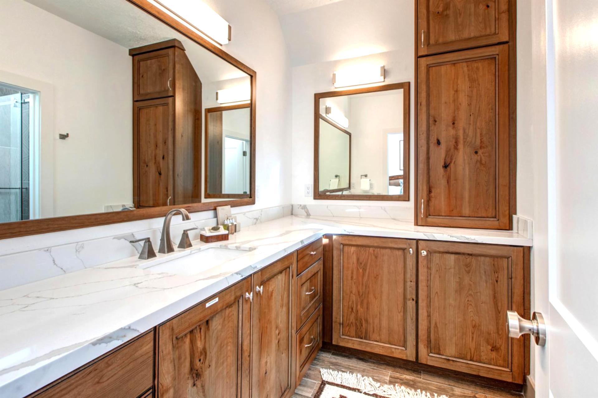 Your en suite bath features a granite dual vanity and walk-in shower stocked with L’Occitane amenities.