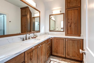 Your en suite bath features a granite dual vanity and walk-in shower stocked with L’Occitane amenities.