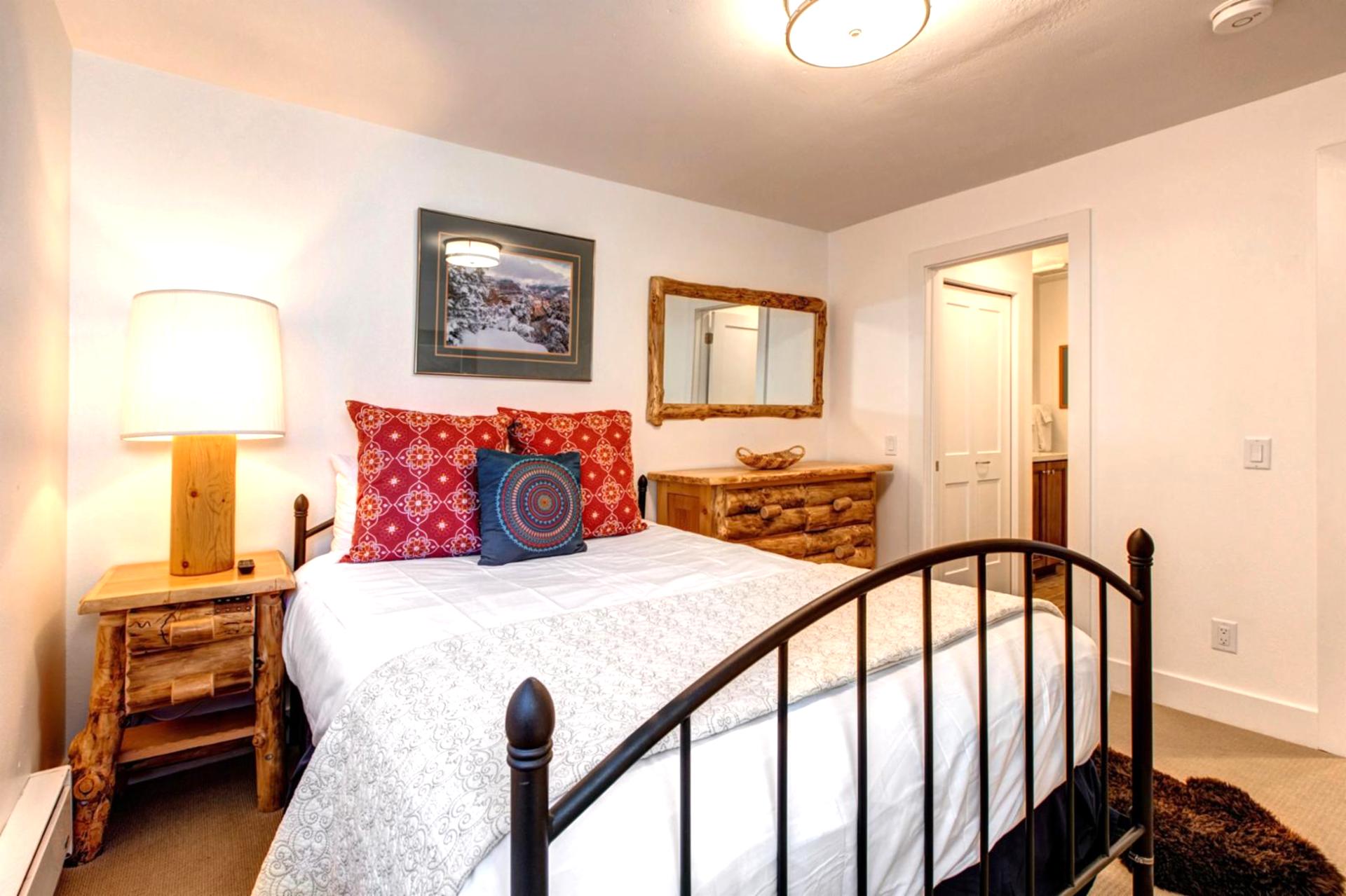 The main-level bunk room is perfect for kids or friends, with seating and warm lighting.