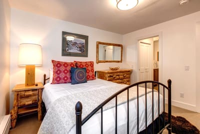 The main-level bunk room is perfect for kids or friends, with seating and warm lighting.