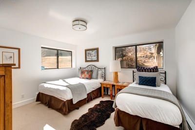 A Queen bed, plush carpet, and large window create a restful lower-level bedroom retreat.