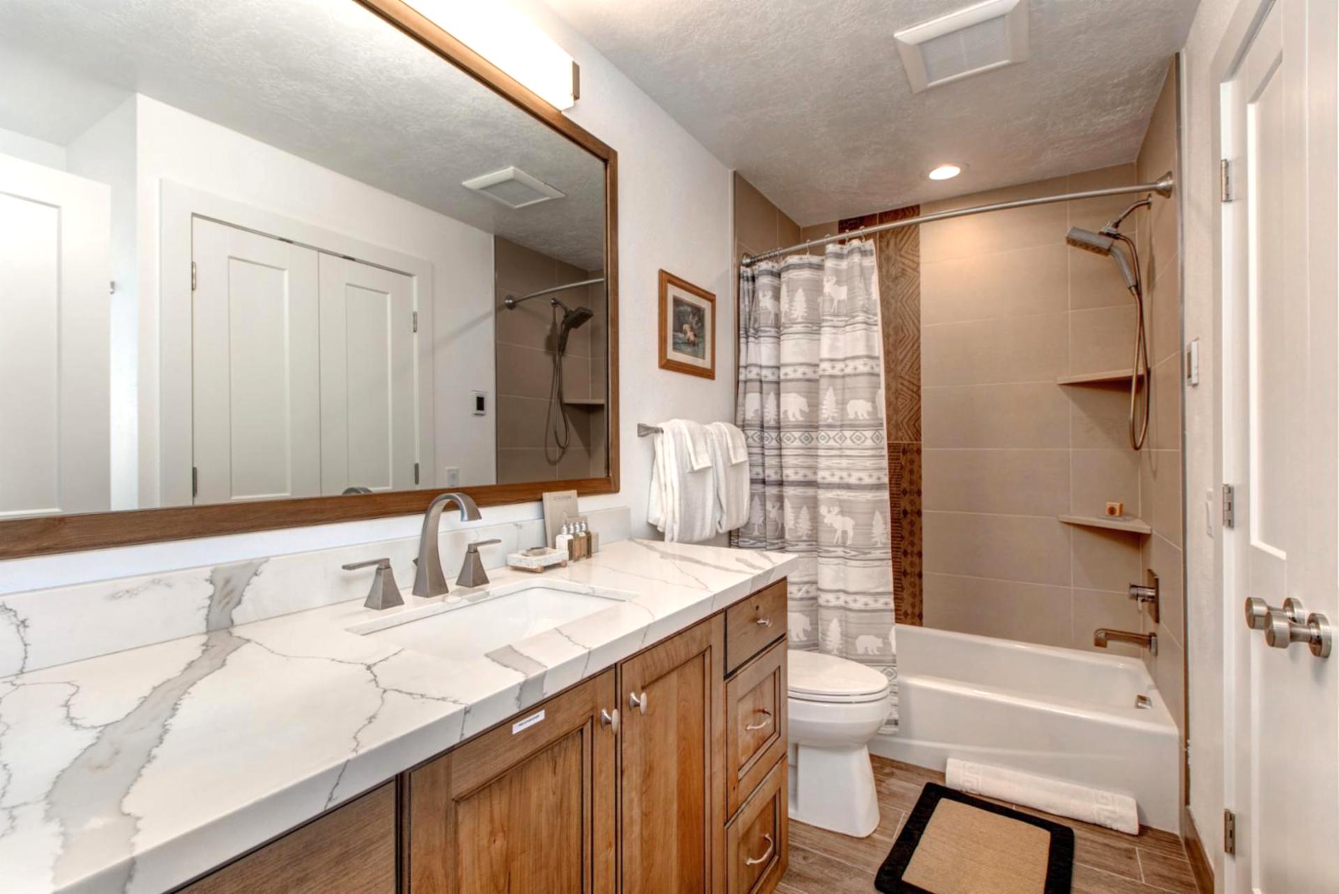 Granite vanity and combo tub/shower provide comfort and convenience on the lower level.