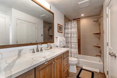 Granite vanity and combo tub/shower provide comfort and convenience on the lower level.