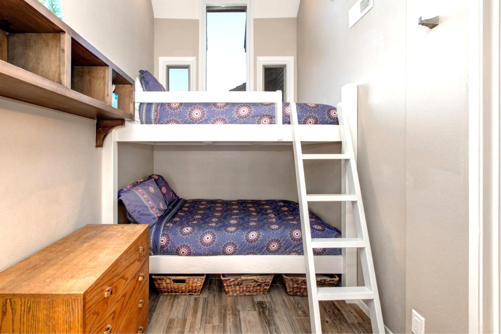 Cozy and well-lit, this versatile bedroom sleeps three with a mix of Queen and Twin beds.