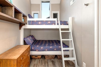 Cozy and well-lit, this versatile bedroom sleeps three with a mix of Queen and Twin beds.