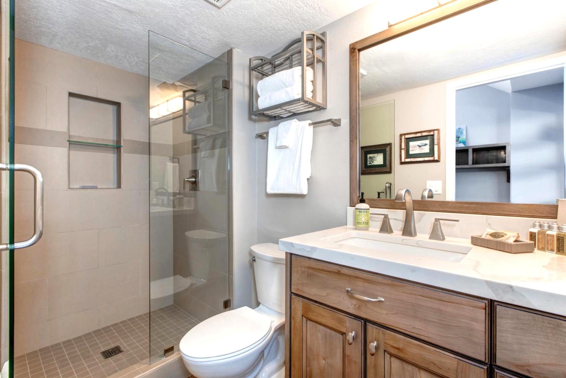 Guest bath includes a full tub and shower combo, granite vanity, and lodge-style accents.