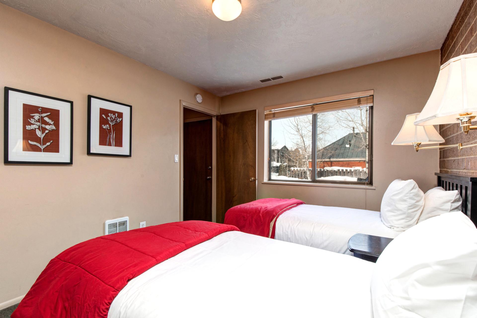 Alternate view shows dual nightstands, reading lights, and ample walking space.