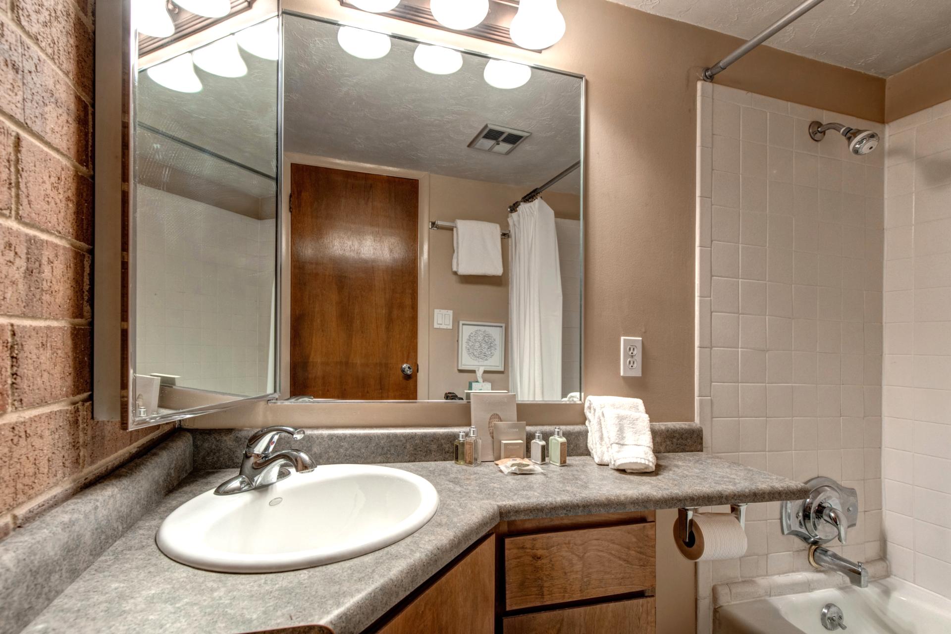Full bath attached to the Twin bedroom, includes shower/tub combo and storage.