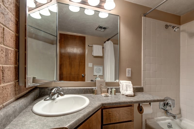 Full bath attached to the Twin bedroom, includes shower/tub combo and storage.