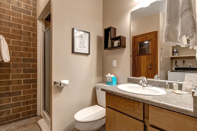 Located near the living room, this convenient fourth bath includes a step-in shower and dry sauna room