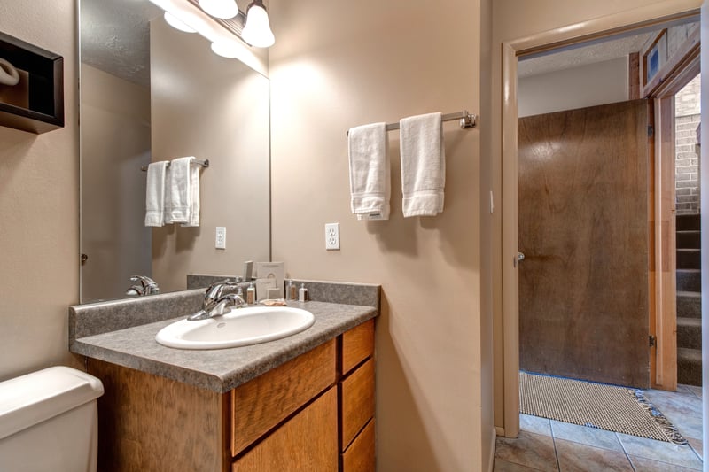 A second angle of the main-level bath with vanity and updated tile.