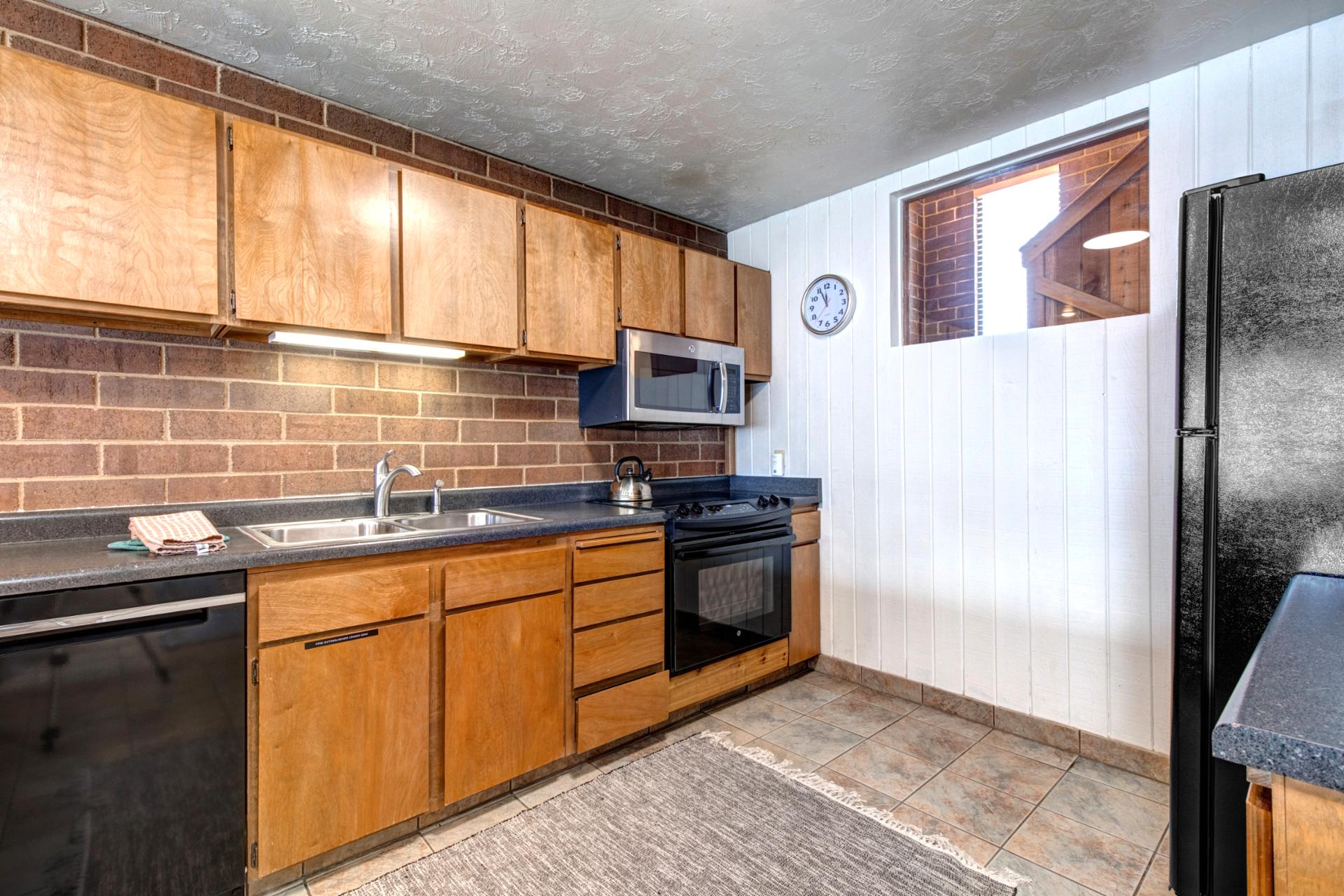Another view of the fully equipped kitchen with modern appliances and a functional layout.