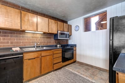 Another view of the fully equipped kitchen with modern appliances and a functional layout.