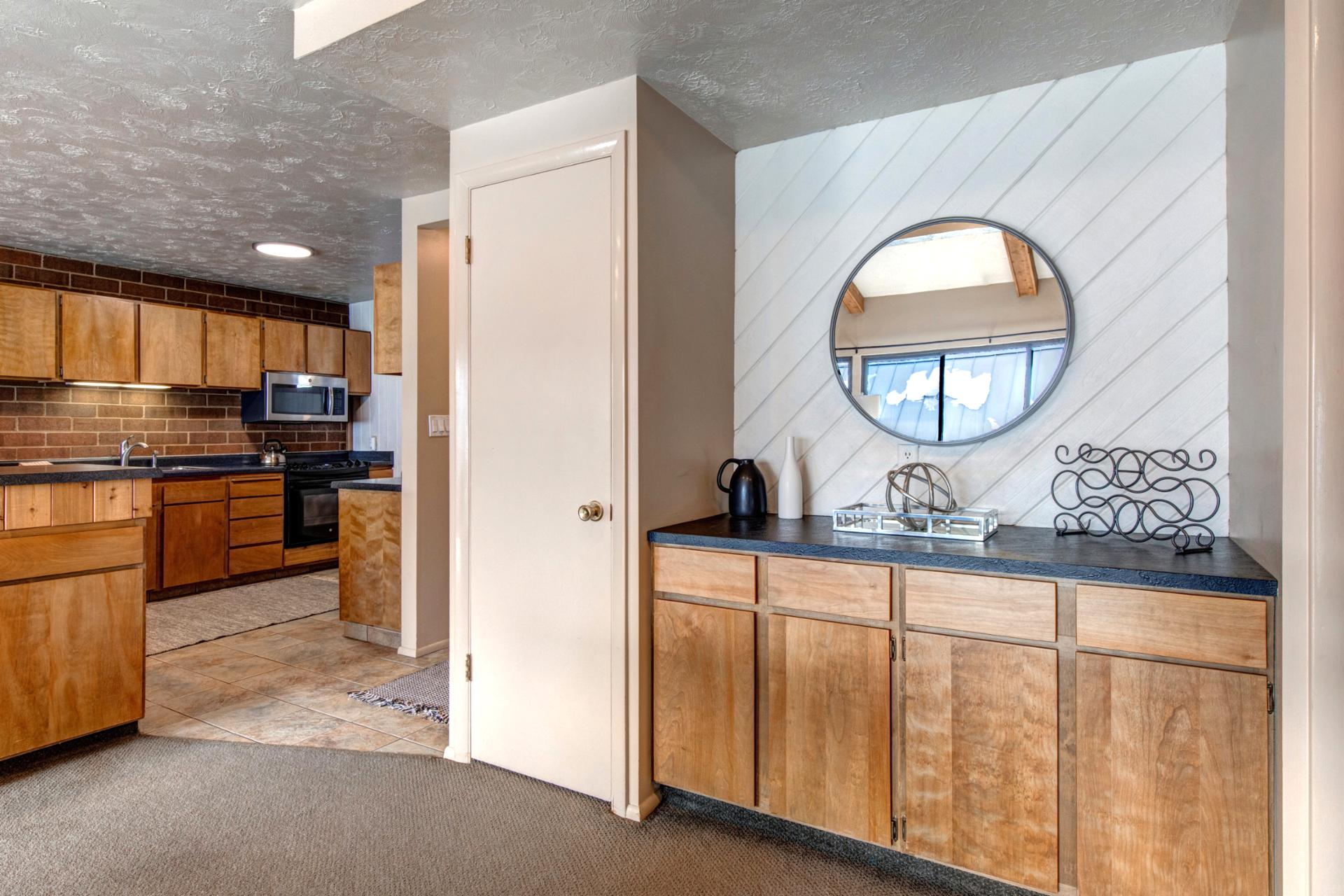 A wide view of the living space shows easy access to the kitchen and additional seating.