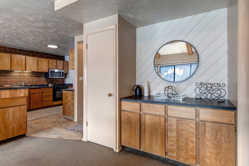 A wide view of the living space shows easy access to the kitchen and additional seating.