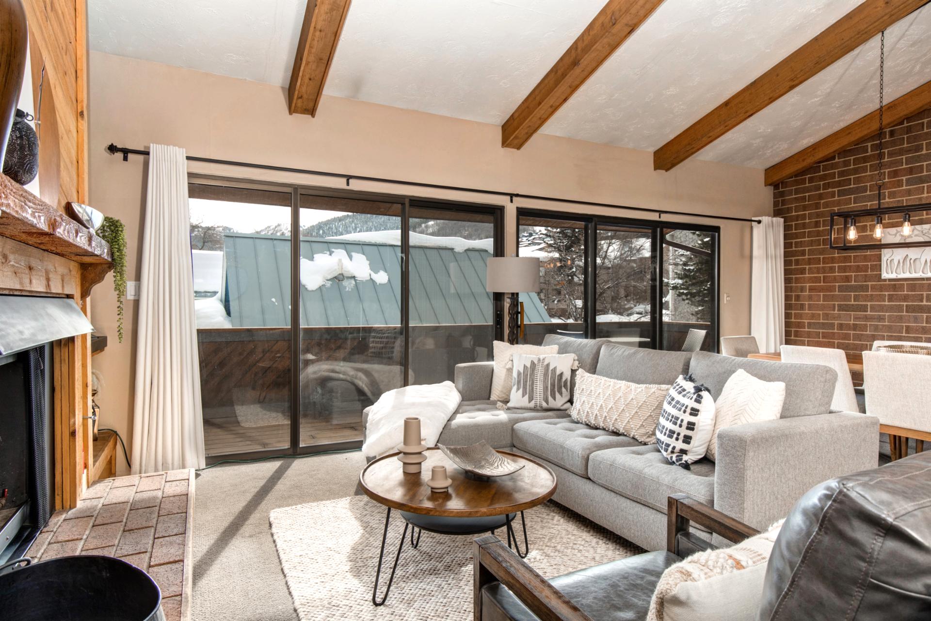 Second view of the living room with plush seating and seamless indoor-outdoor flow.