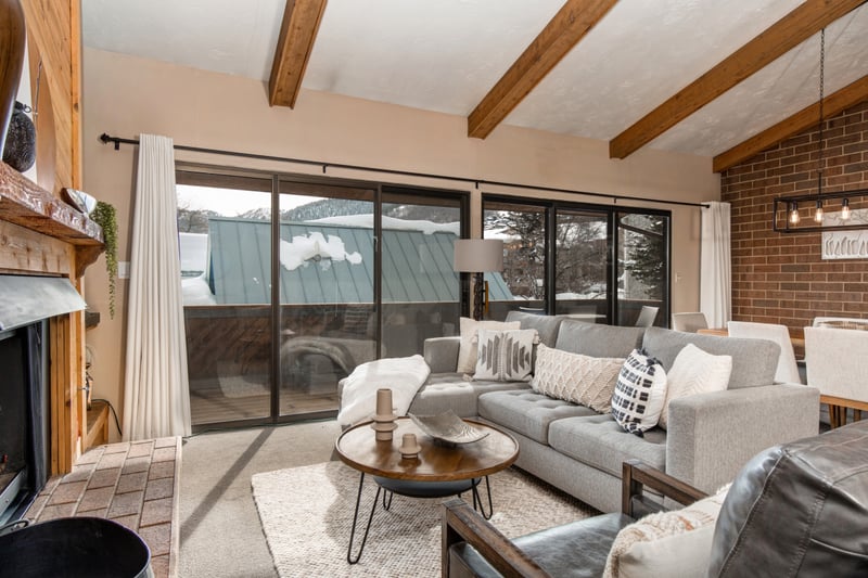 Second view of the living room with plush seating and seamless indoor-outdoor flow.