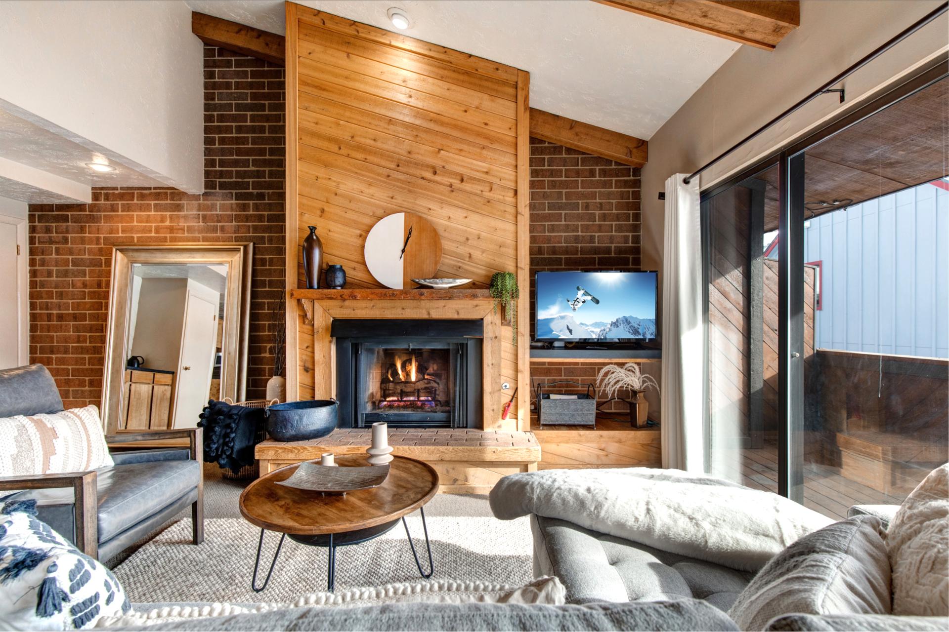 Cozy up after the slopes with a movie by the fire and warm mountain textures throughout.