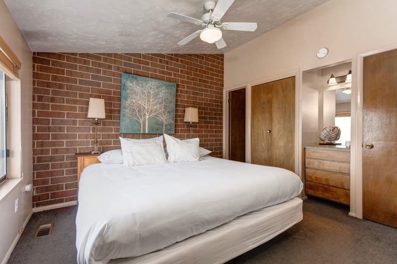 Guest room with king bed, with mountain lodge charm.