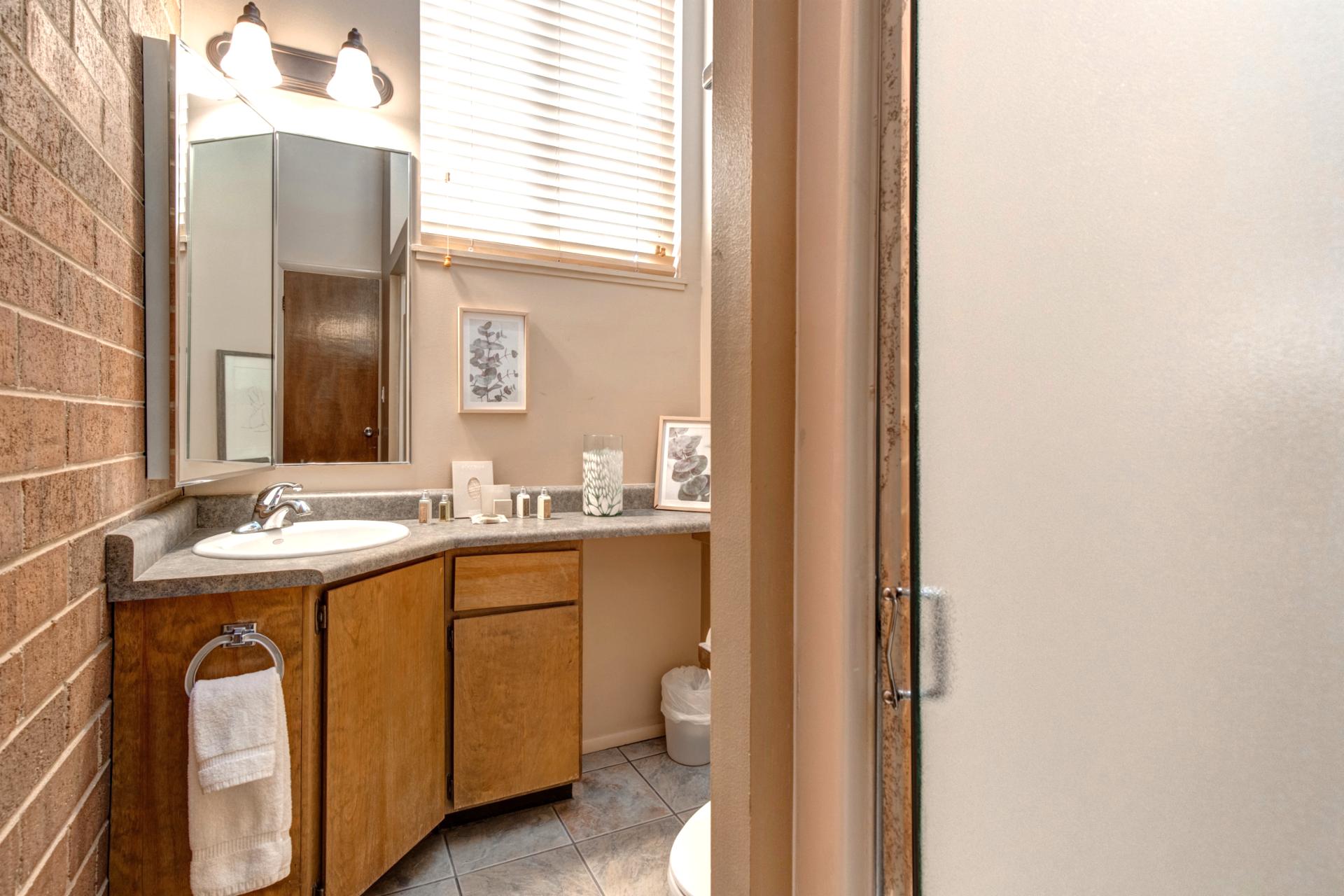 Attached to Bedroom 2, this bath includes a step-in shower and granite vanity.