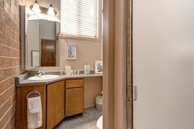 Attached to Bedroom 2, this bath includes a step-in shower and granite vanity.