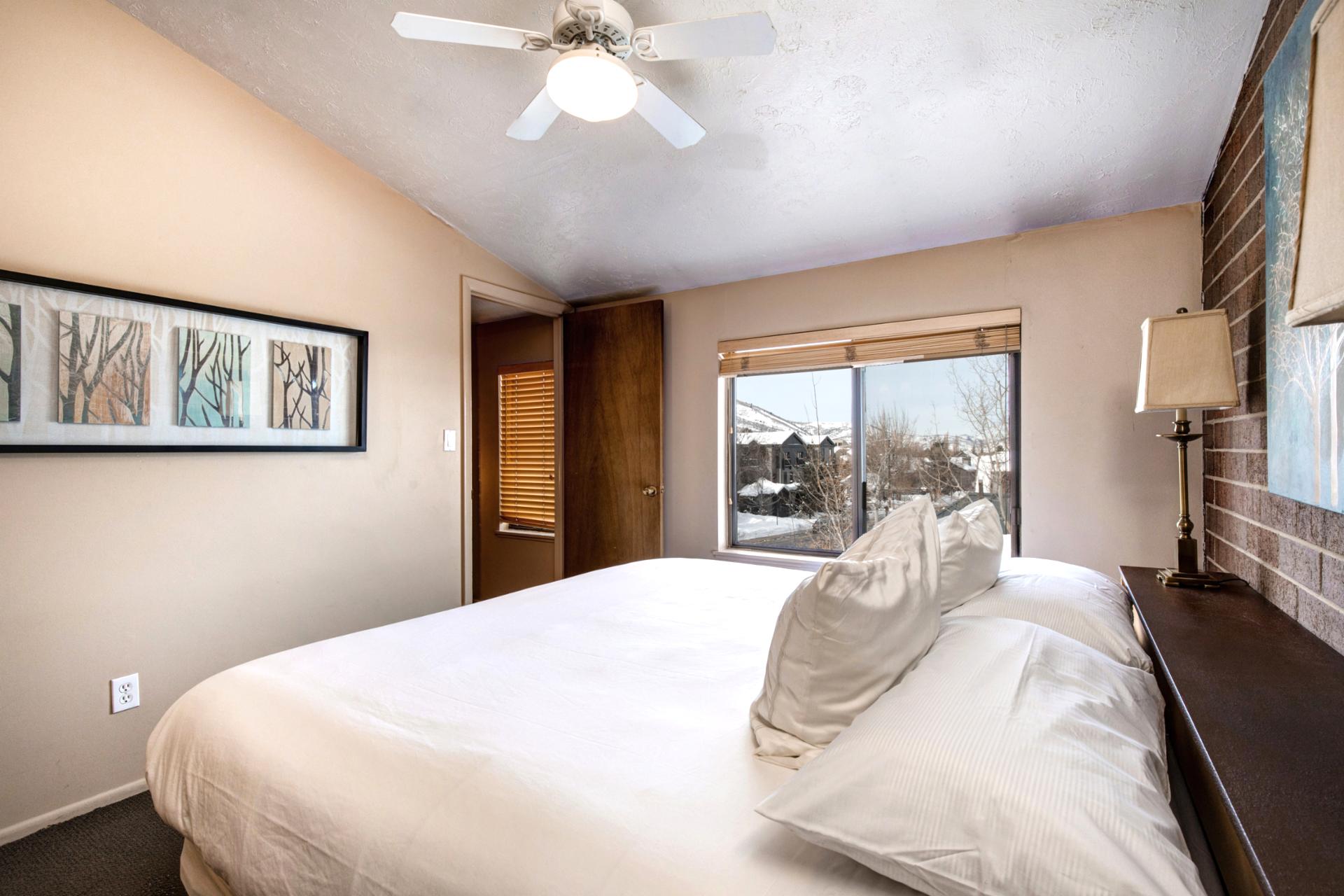 Second view of Bedroom 3 with twin layout, dresser, and natural light.