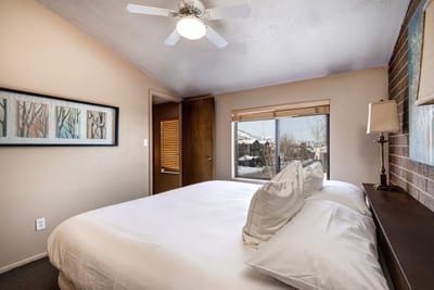 Second view of Bedroom 3 with twin layout, dresser, and natural light.