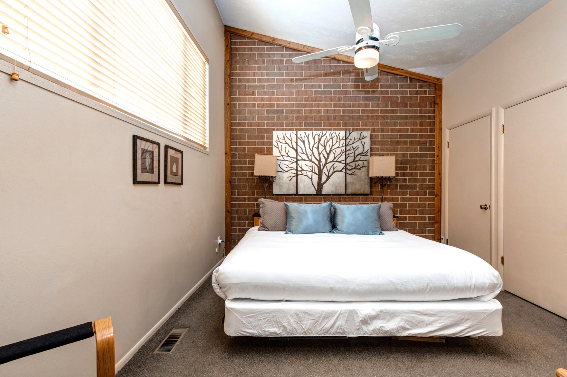 Alternate angle of Bedroom 1 with brick detail and reading lights.