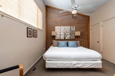 Alternate angle of Bedroom 1 with brick detail and reading lights.