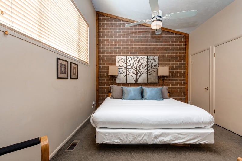 Alternate angle of Bedroom 1 with brick detail and reading lights.