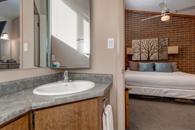 Additional view of the vanity and mirrored storage in the ensuite.