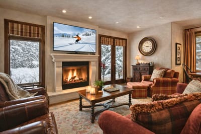 Stay cozy fireside in the spacious living room with plush seating, large Smart TV, and beautiful views. VIN-14