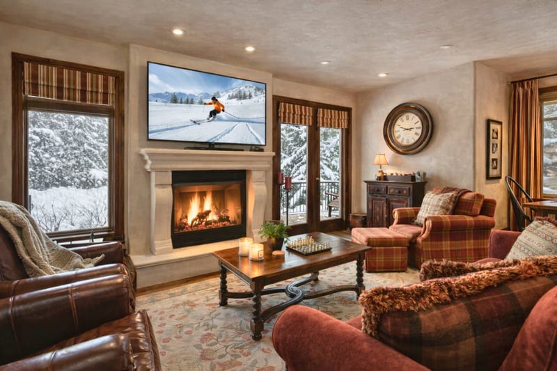 Stay cozy fireside in the spacious living room with plush seating, large Smart TV, and beautiful views. VIN-14