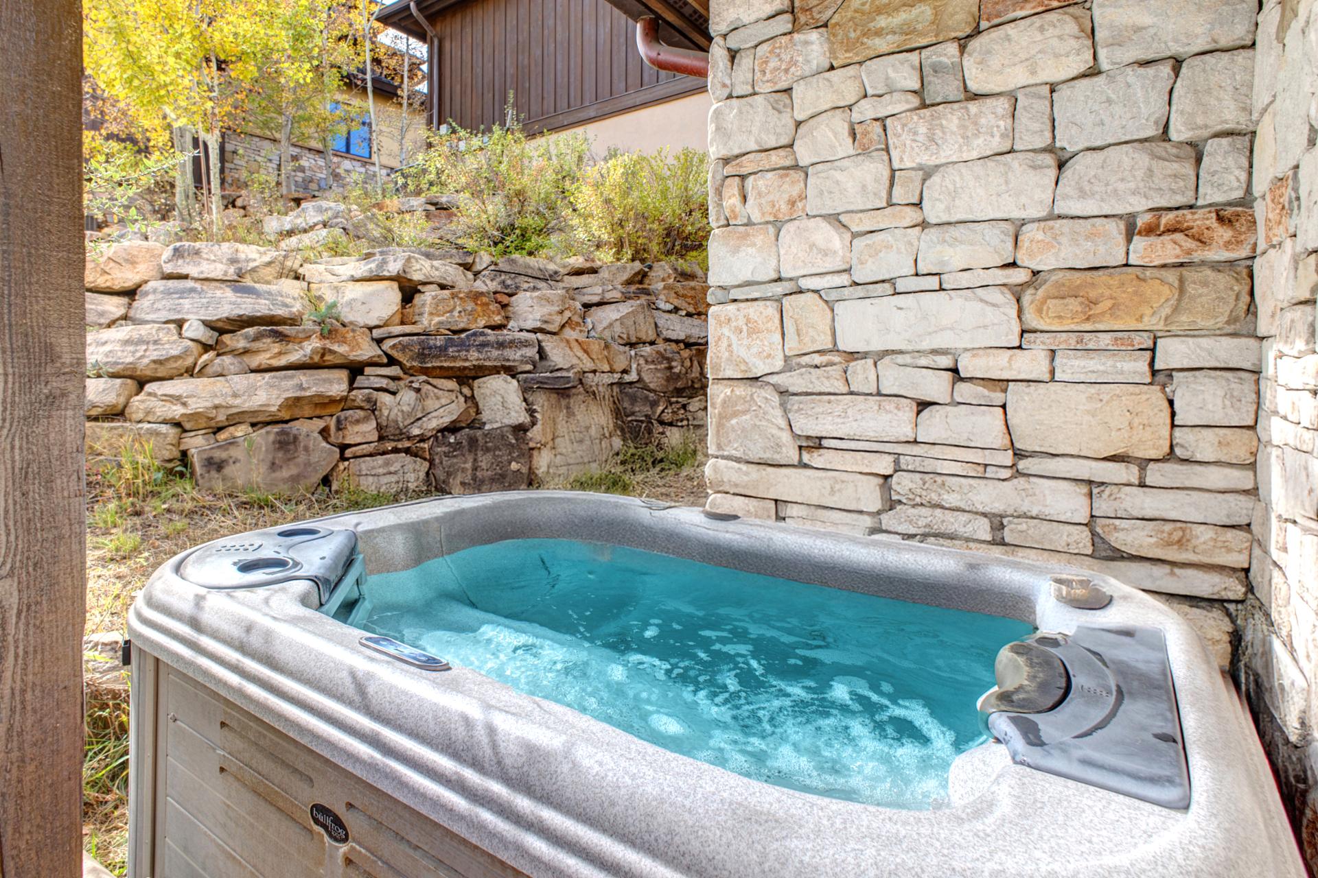 End your day with a long soak in the private outdoor hot tub, nestled beneath stone and pine.