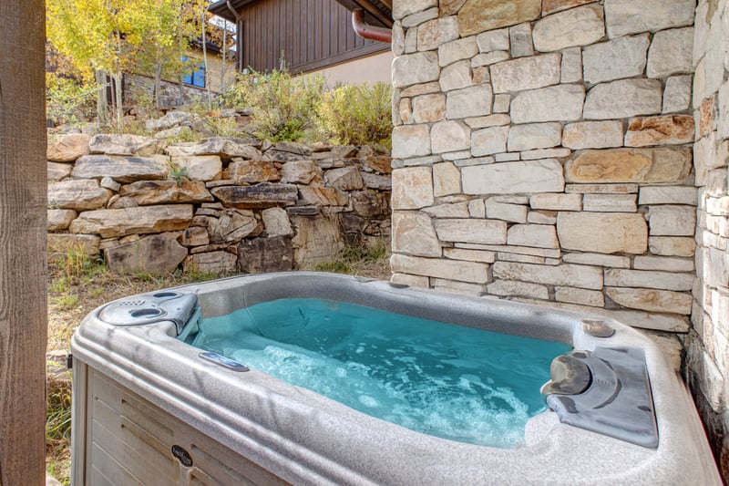 End your day with a long soak in the private outdoor hot tub, nestled beneath stone and pine.