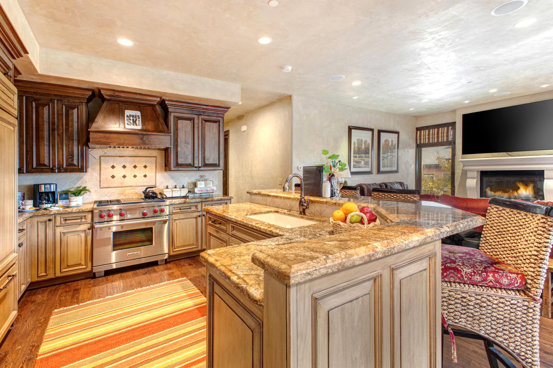 Your chef’s kitchen includes granite counters, premium appliances, and a central island for easy prep and serving.







