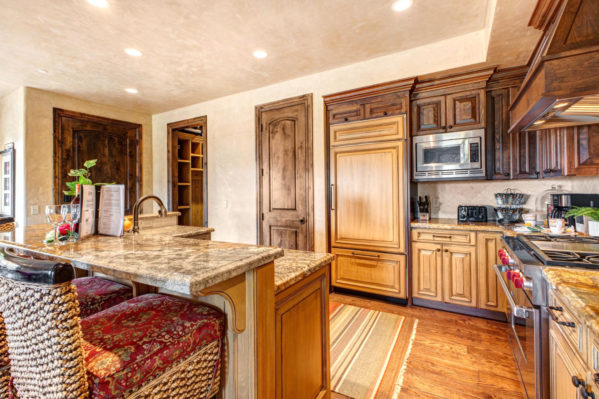 Enjoy cooking at home with a fully equipped kitchen, bar seating, and open layout.