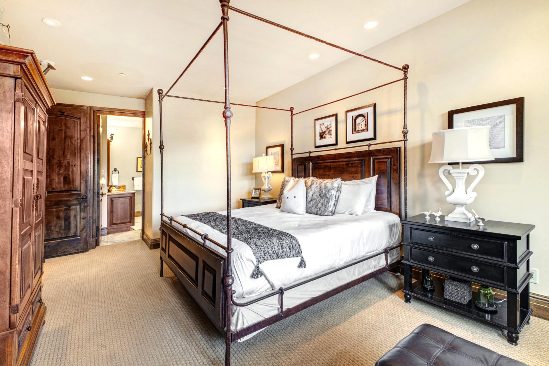 Your primary suite includes a King bed, plush lounge chair, and access to the luxurious en suite bath.