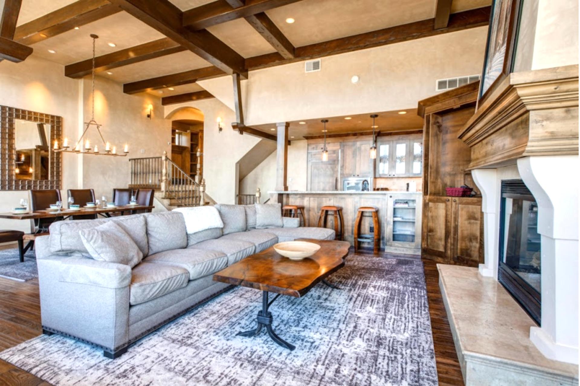 Enjoy mountain ambiance with exposed beams, stone fireplace, and soft leather seating in the great room.