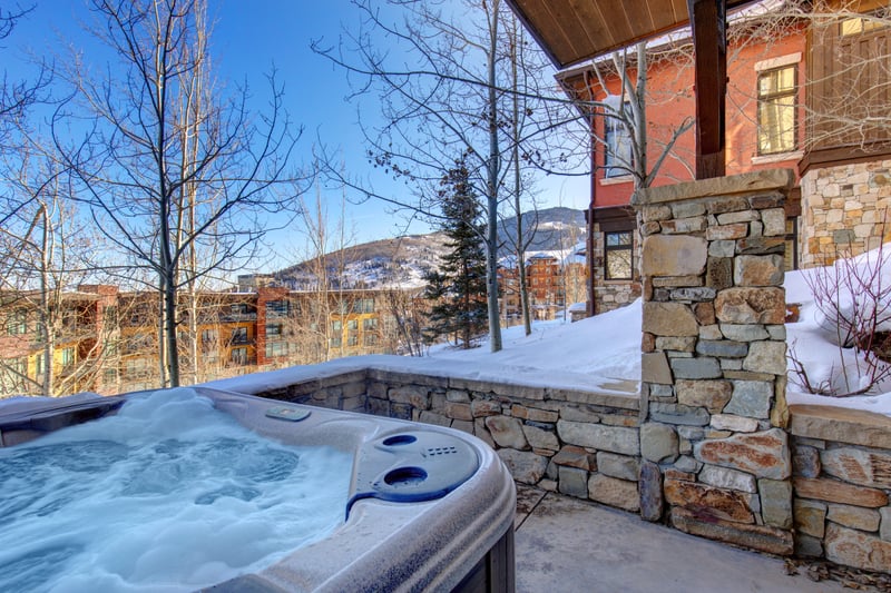 Soothing hot tub retreat with snowy mountain views and serenity.