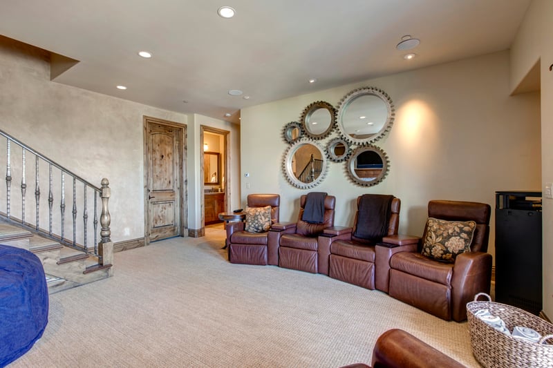 Downstairs entertainment room features Smart TV, oversized seating, and space to unwind as a group.