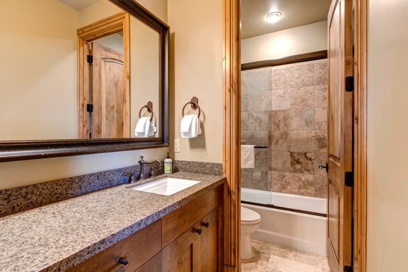 Rustic elegance meets modern comfort in this warm-toned bathroom retreat.