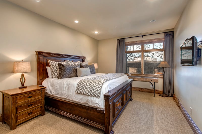 Downstairs King bedroom includes full closet, peaceful decor, and adjacent hall bath.