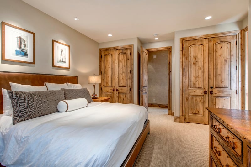 Guest bedroom includes a King bed, ensuite bath, and peaceful mountain tones.