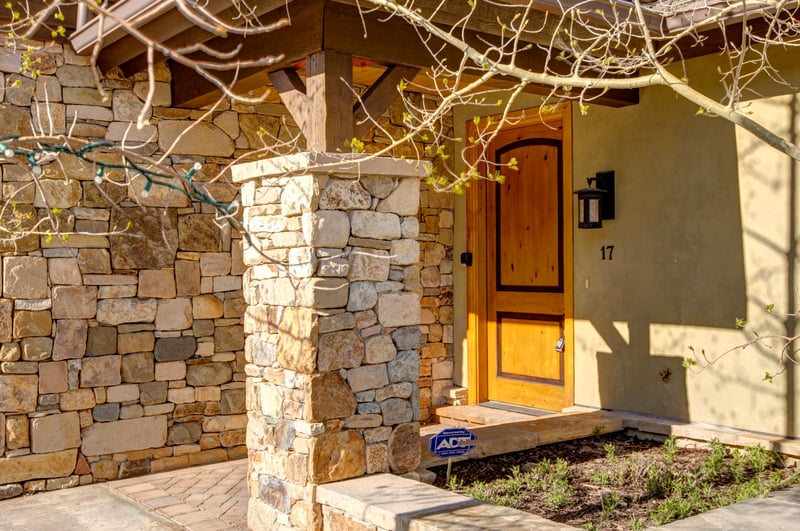 Charming stonework and wood beams frame the entrance to your luxury Park City retreat.