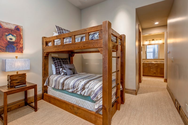 This spacious bunk room offers plenty of sleeping space with lodge-style furnishings.