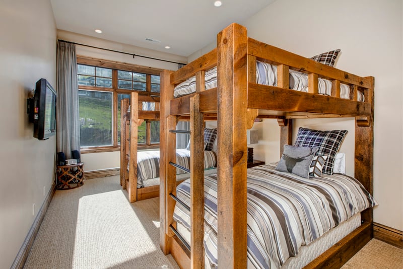 Rustic bunk room with mountain views, and TV.